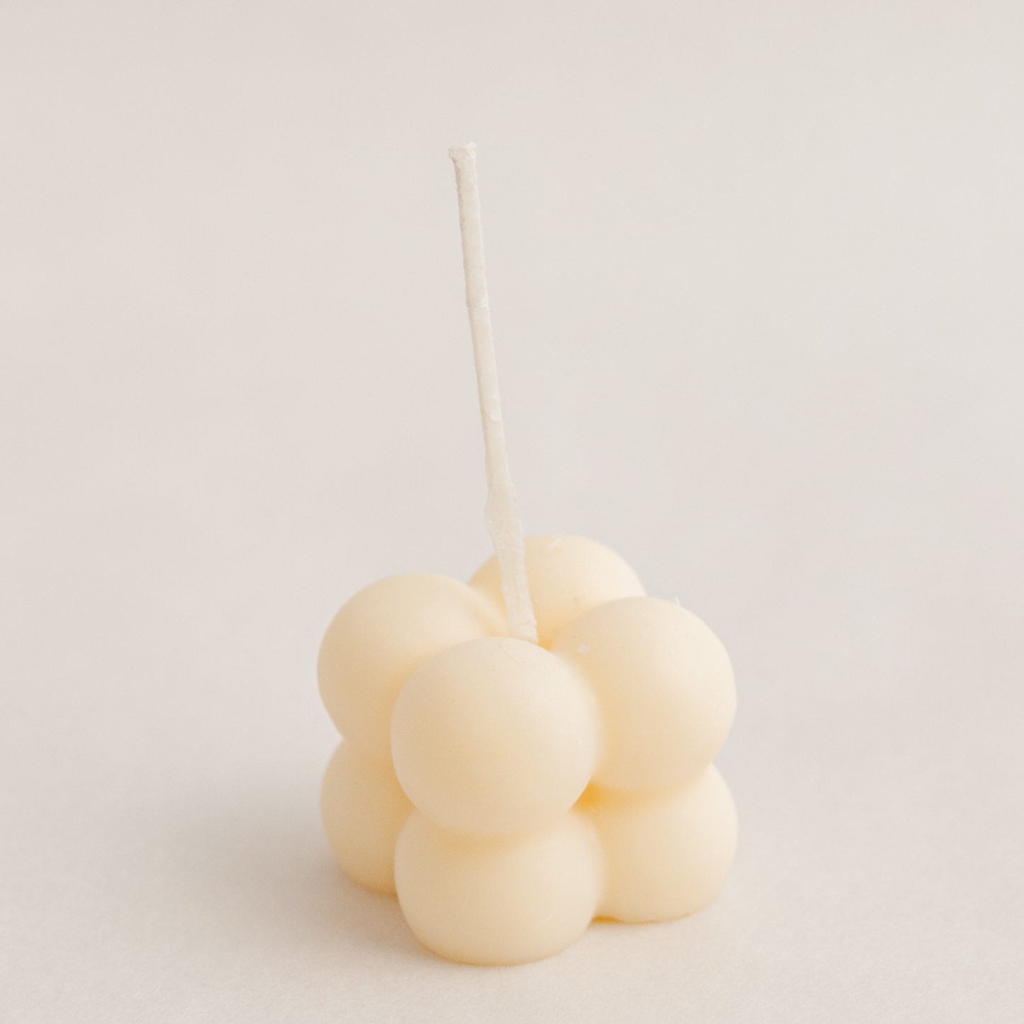 Small bubble cube candle in ivory colour, handmade with soywax in UAE. Perfect for birthday or wedding favours, corporate gifts, order today at minoocandles dot com