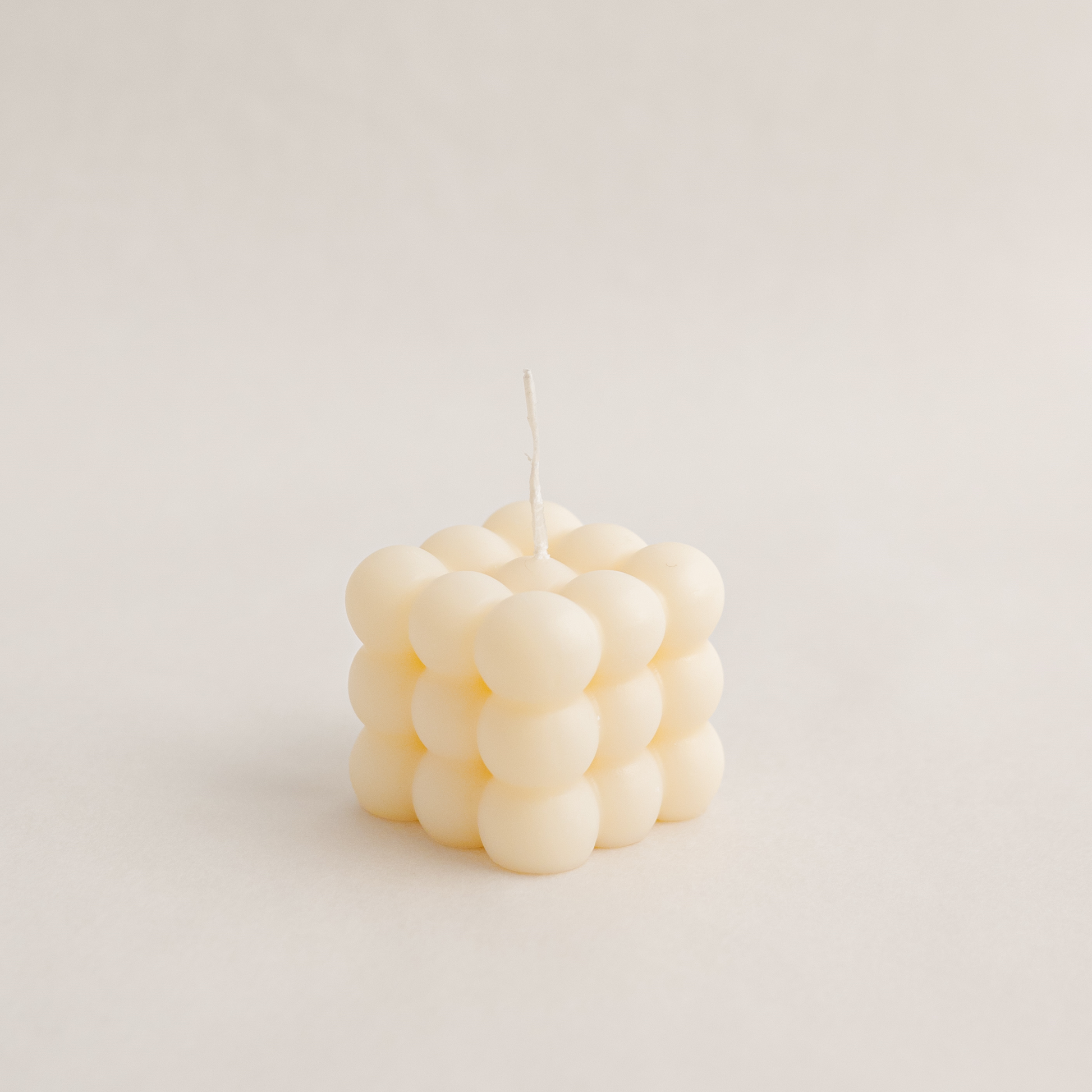 Medium bubble cube candle in ivory colour, handmade with soywax in UAE. Perfect for birthday or wedding favours, corporate gifts, order today at minoocandles dot com