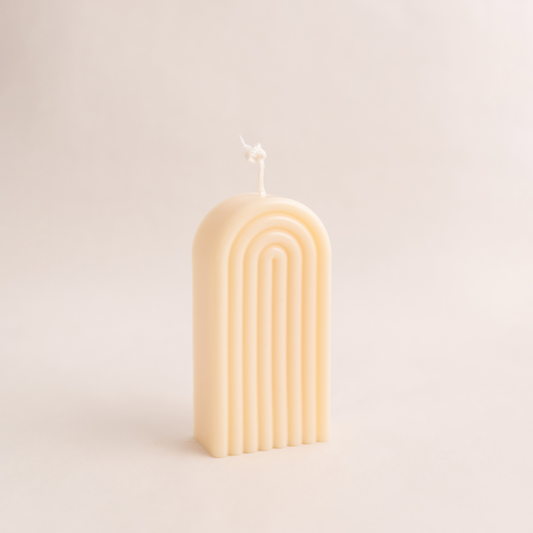 Handmade rainbow arch pillar candle made of soy wax in colour ivory with a lead-free wick. Customization options available for decorative candles in UAE at minoocandles dot com