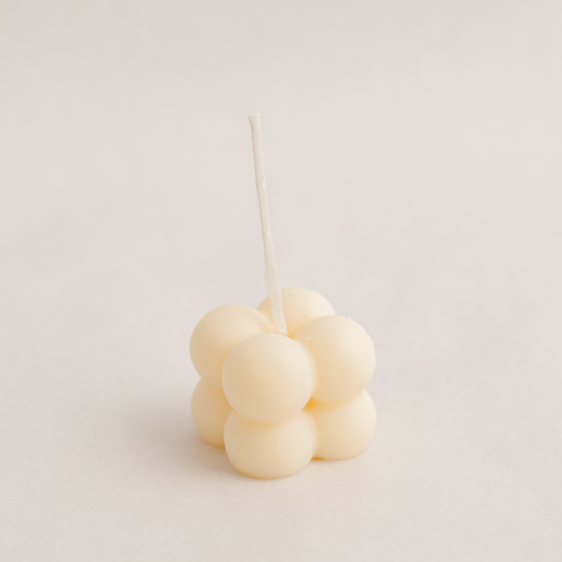 Small bubble cube candle in ivory colour, handmade with soywax in UAE. Perfect for birthday or wedding favours, corporate gifts, order today at minoocandles dot com