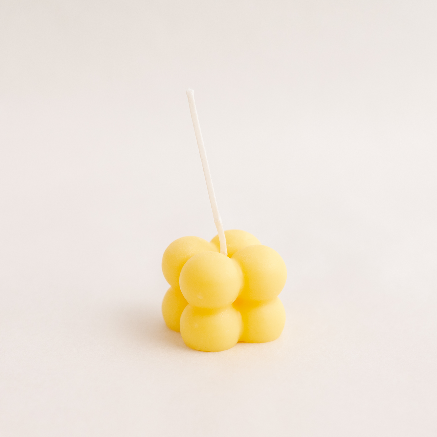 Small bubble cube candle in yellow colour, handmade with soywax in UAE. Perfect for birthday or wedding favours, corporate gifts, order today at minoocandles dot com