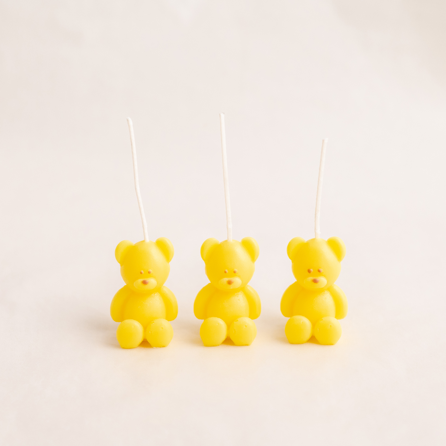 Three cute kawaii handmade bear candles made of soy wax in colour yellow with a lead-free wick. Customization options available for decorative candles in UAE at minoocandles dot com