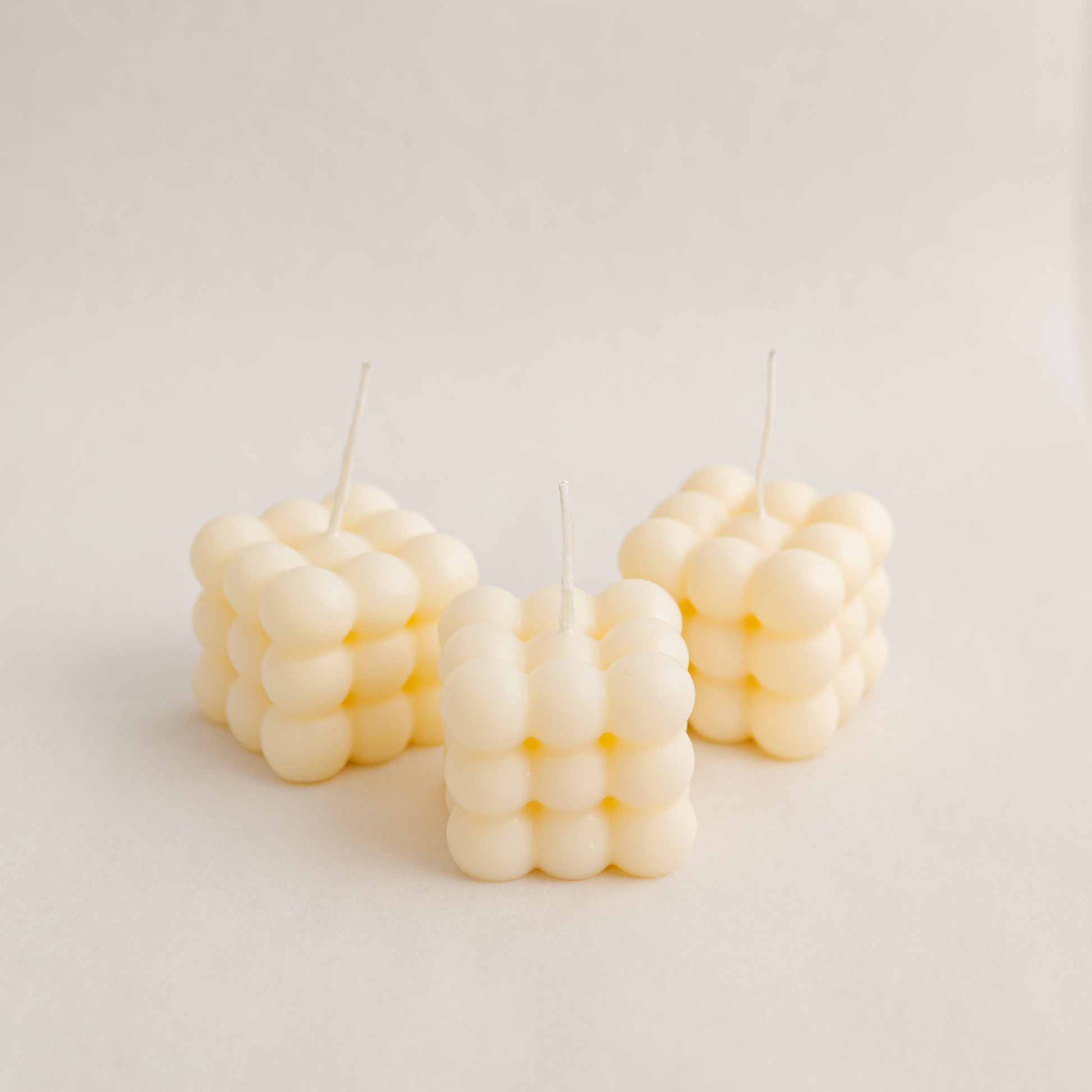 three Medium bubble cube candle in ivory colour, handmade with soywax in UAE. Perfect for birthday or wedding favours, corporate gifts, order today at minoocandles dot com